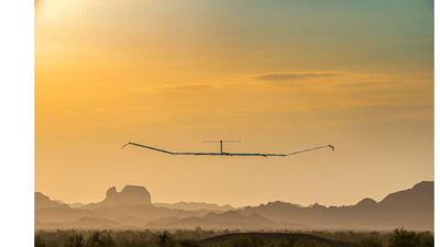 The unmanned Zephyr Airbus drone flies over the sunset. 
