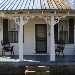 A small white house with a porch in Cullman, Alabama. 