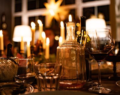 Wine carafe and glasses on candlelit table