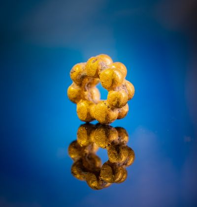 gold bead on blue background