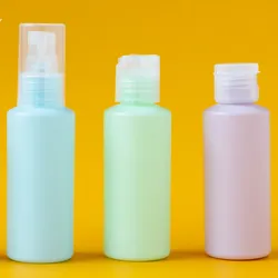 four small cosmetics bottles cleared for airport security, yellow background