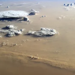 Dust dances over the Sahara Desert in this image taken from the ISS in 2014. 