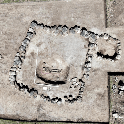 Aerial view of skeleton surrounded by stones
