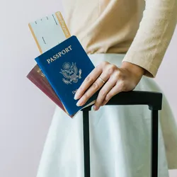 Closeup of girl holding passports and boarding pass
