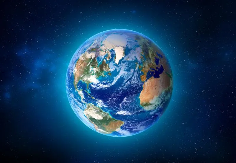 A digital image of the Earth seen from space. The centre of the planet is focused on the Atlantic. There are clouds scattered across the representation and the whole thing is floating in the blue/black void of space with white starts in the background.  