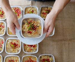 individual servings of ashure lined up on a wooden countertop