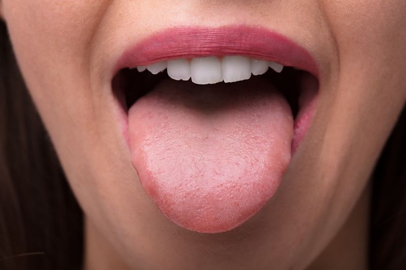 Close-up Photo Of A Woman Showing Tongue