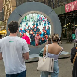 A circular screen in Dublin showing video from New York.