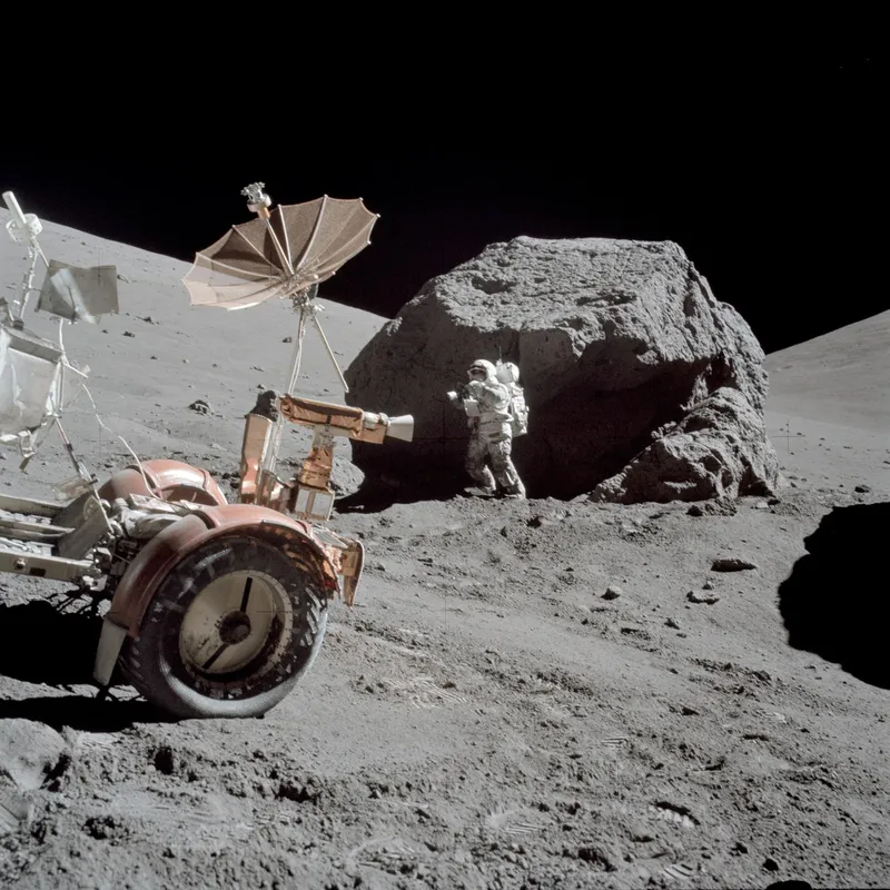 Astronaut Harrison Schmitt standing next to boulder during the Apollo 17 mission in December 1972.
