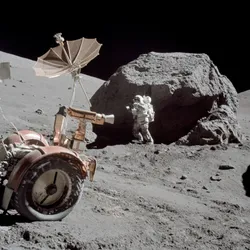 Astronaut Harrison Schmitt standing next to boulder during the Apollo 17 mission in December 1972.