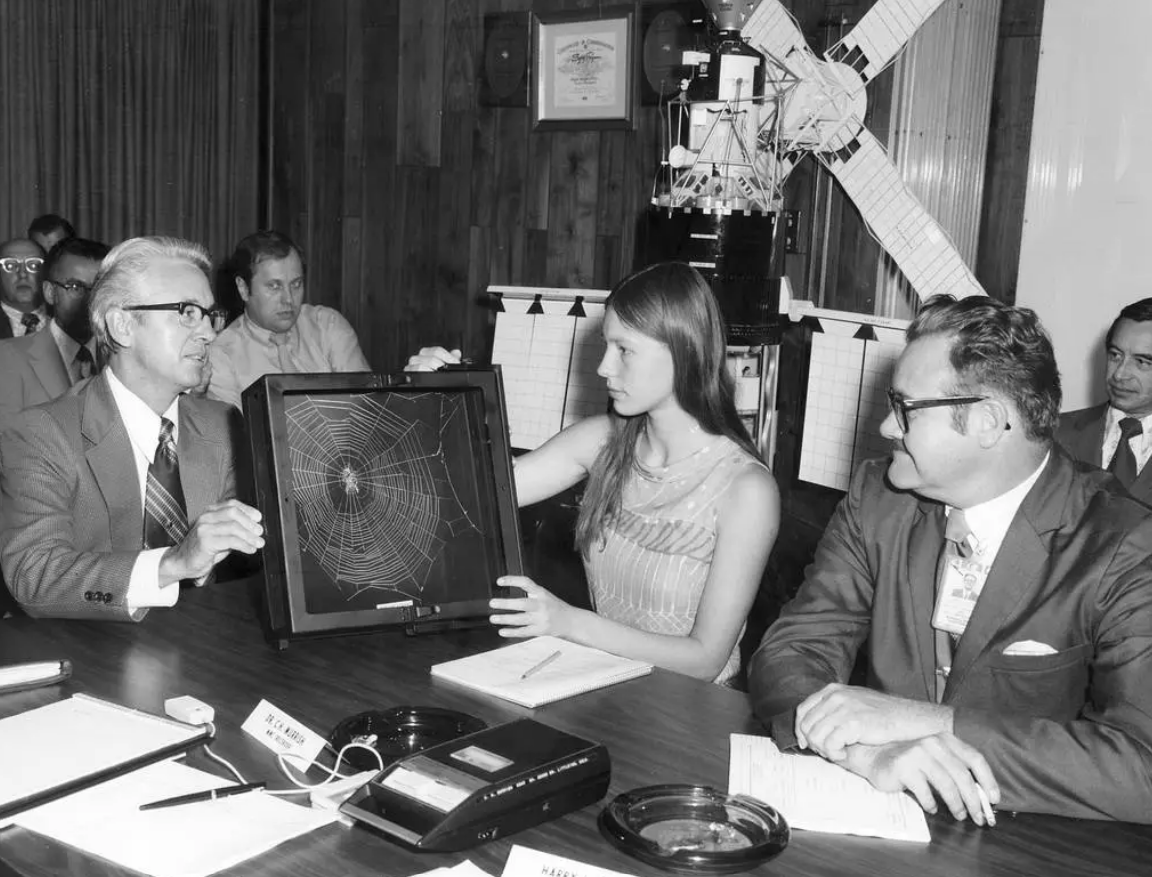 High school student Judith Miles discusses her proposed Skylab experiment with Keith Demorest and Henry Floyd, both of Marshall Space Flight Center, in 1972.