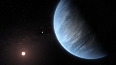 This Illustration shows the super-earth exoplanet K2-18b, its host star and an accompanying planet in this system. K2-18b is known to host both water and temperatures that could support life.