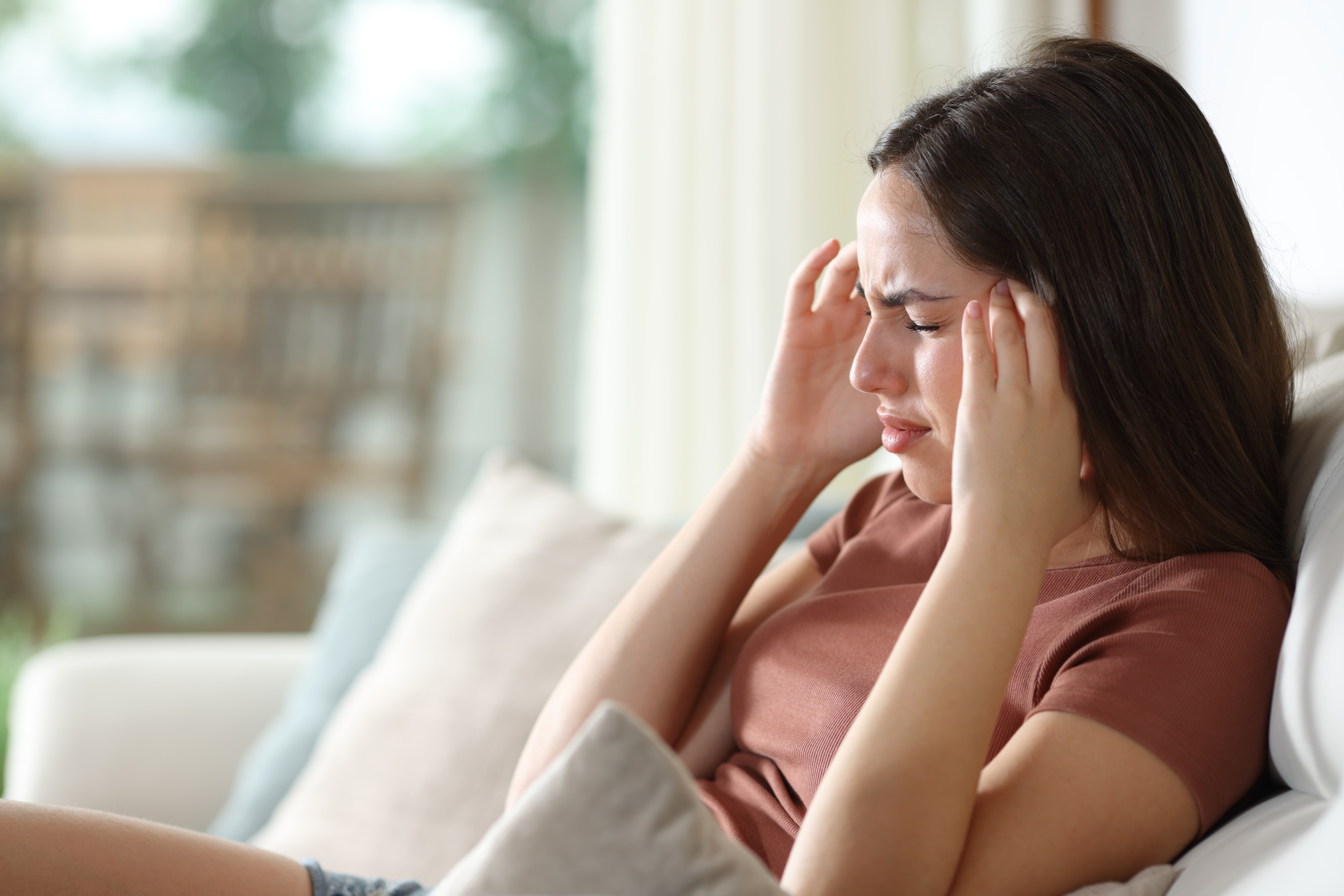 Woman touching her head in pain