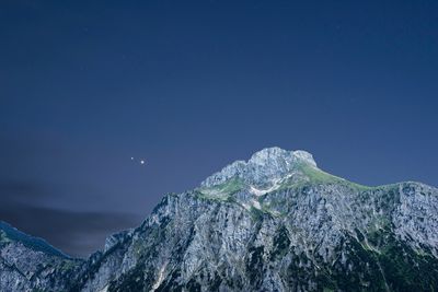 A photo of mountains and jupiter and venus in the sky.
