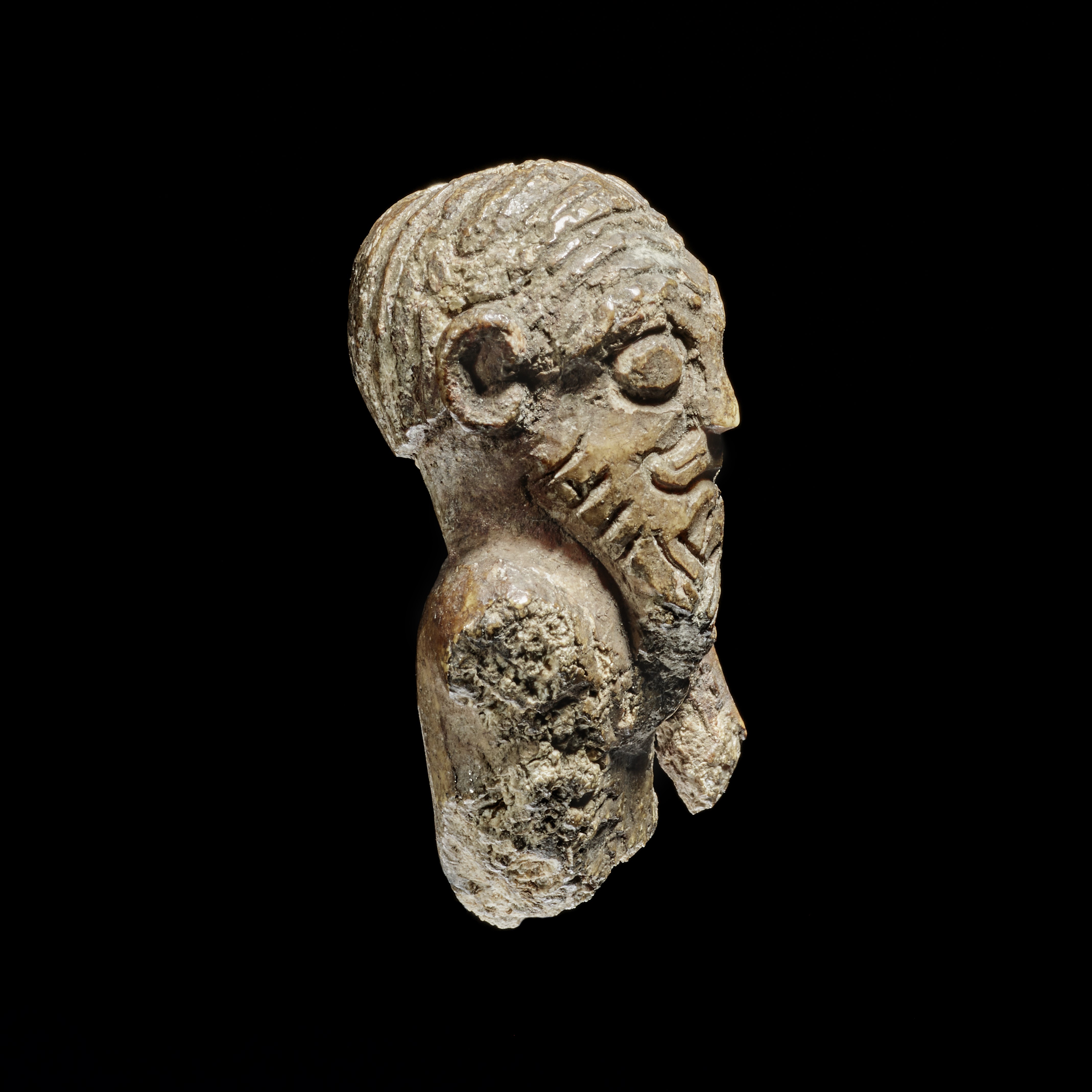 Viking game piece depicting Norse hairstyle