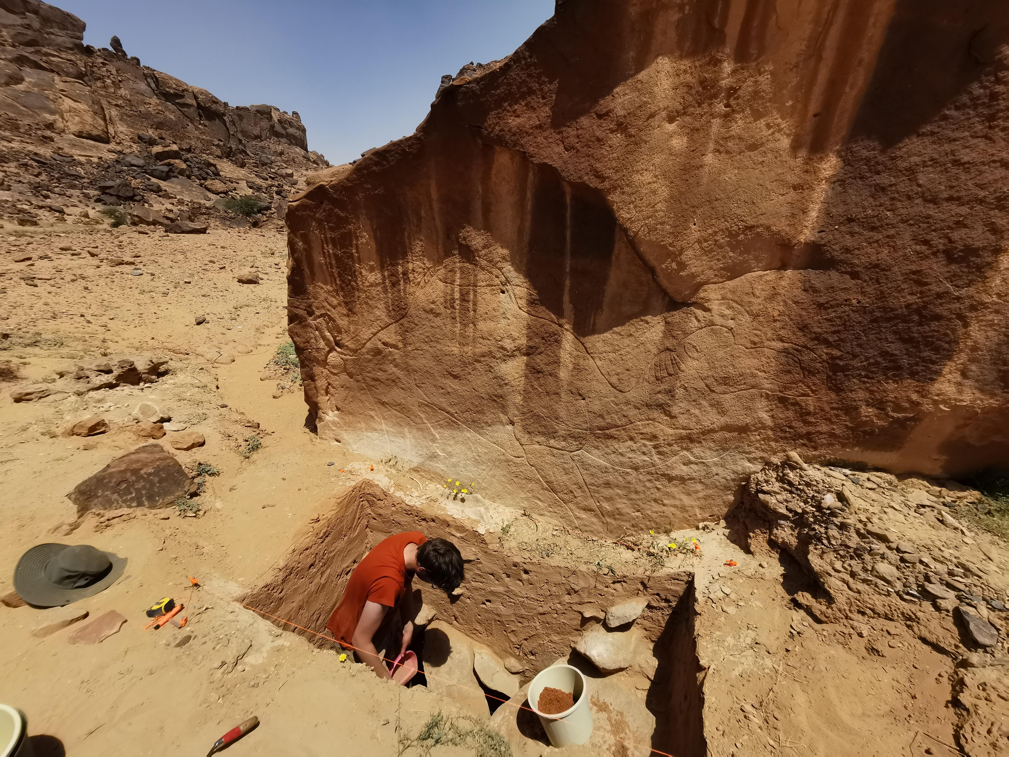 Desert Archaeology: Excavation of Trench 1 directly beneath a rock art panel at Jebel Arnaan, where an engraving tool was discovered.