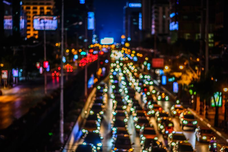 A blurry city scene of a busy highway with cars in Bangkok