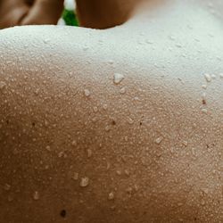 Sweat dripping down a man's back.