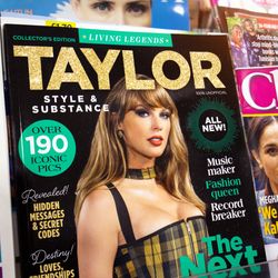celebrity magazines on a shelf, with a close up on a cover featuring Taylor Swift