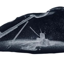 a view of the liquid nugget of metal and inside thin gray crystals forming.