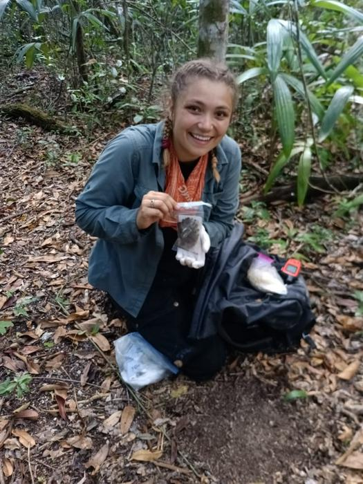 Zoologists get ridiculously excited about finding droppings, in this case Ellen Dymit with cat scat.