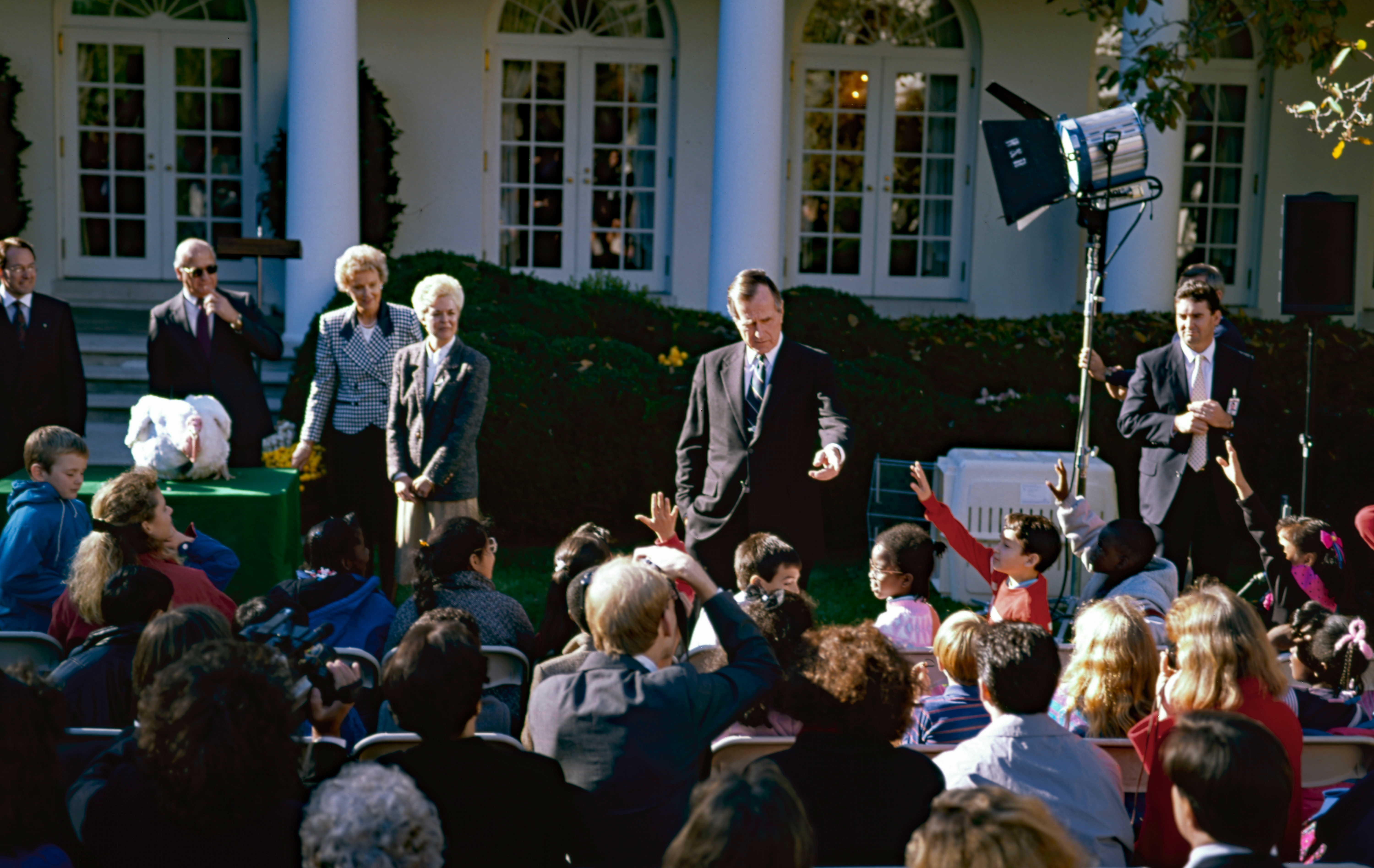 Washington DC, USA, November 14, 1990. President George H.W. Bush answers a question from one of the children attending the annual Thanksgiving turkey pardoning in the Rose Garden of the White House