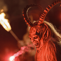 A devil character with a flame celebrating a Krampusnacht Christmas festival tradition in Europe