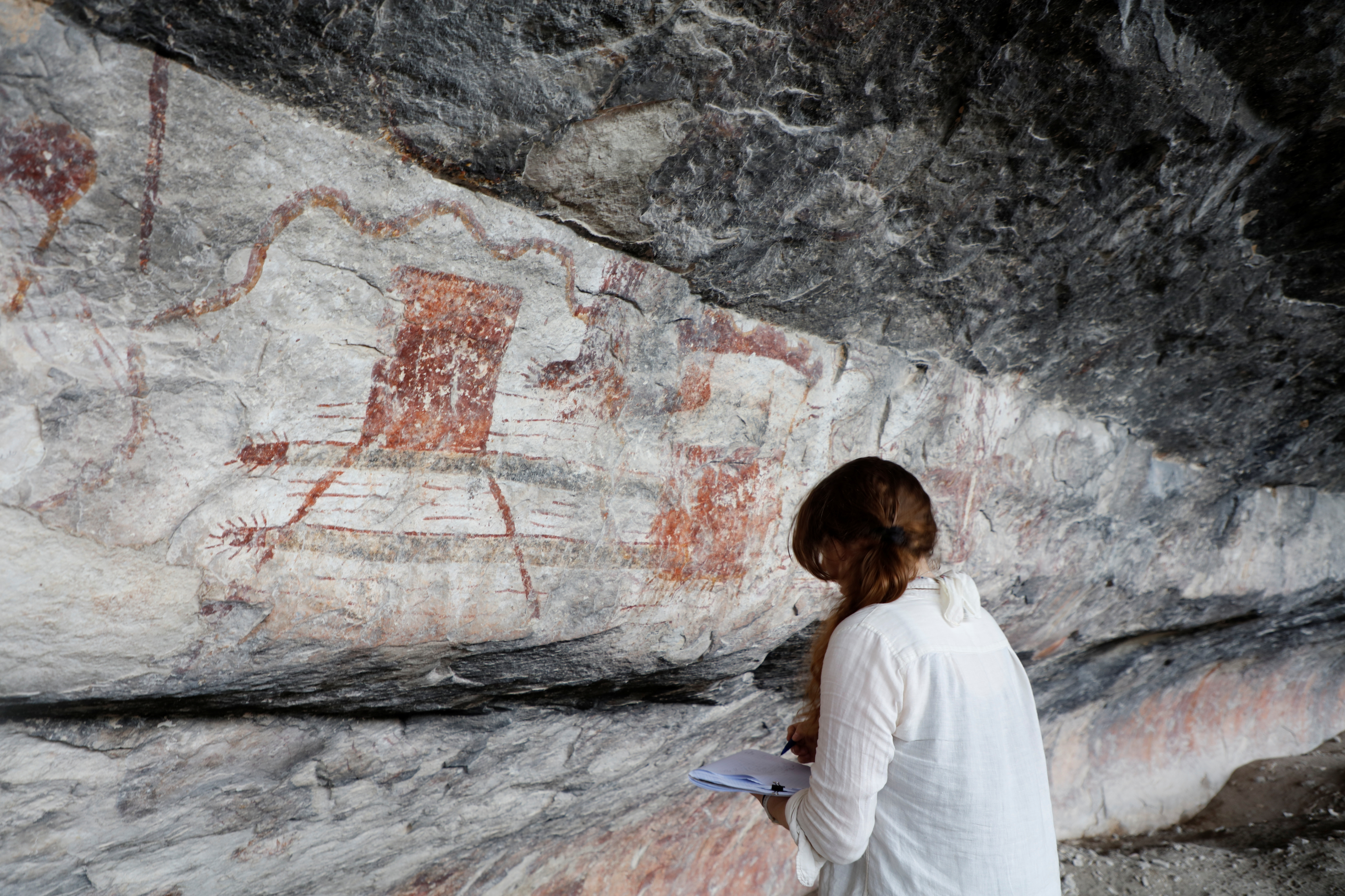 Archaeologist drawing a rock art panel at Seminole Canyon State Park & Historic Site.