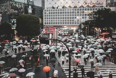 People walking across a busy city crossing road, Shibuya Crossing in Japan