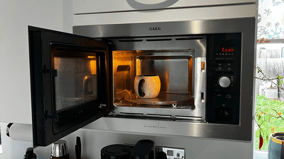 A microwave with a mug inside it.