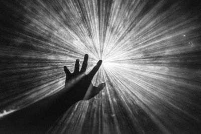 A hand reaching out to the sky.