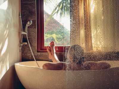 A woman in a bath tub bathering.
