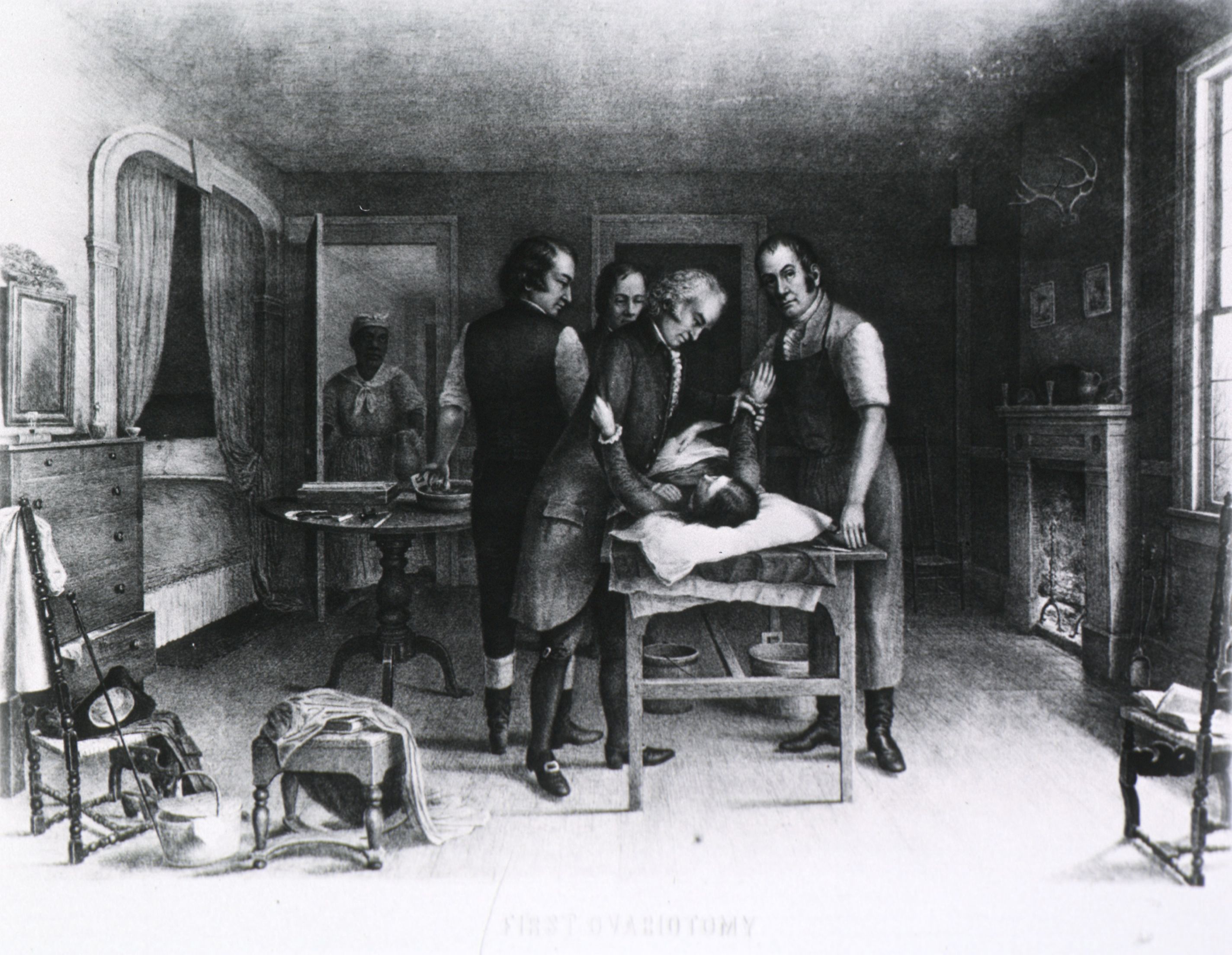 Ephraim McDowell and assistants perform first ovariotomy in America. Interior view: a woman is restrained on a table in a bedroom while McDowell operates; a fireplace is to the right, a table with instruments to the left; a black woman stands at the door Ephraim McDowell and assistants perform first ovariotomy in America. Interior view: a woman is restrained on a table in a bedroom while McDowell operates; a fireplace is to the right, a table with instruments to the left; a black woman stands at the door
