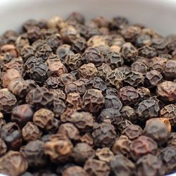 Black pepper, peppercorns, in a bowl