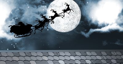illustration of silhouette of santa's sleigh over a rooftop flying across the full moon