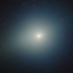 the comet is fuzzy and bright among the black background