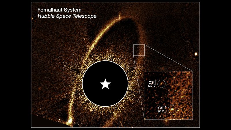 This composite Hubble Space Telescope image shows the debris ring and dust clouds cs1 and cs2 around the star Fomalhaut. They are tiny dots among many similar ones but none quite as bright.