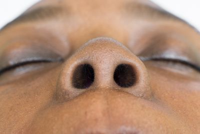 Close-up of a Black woman's nose showing perfectly round nostrils 