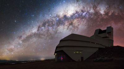 the observatory with behind an incredible night sky with the curve of the Milky way and countless stars