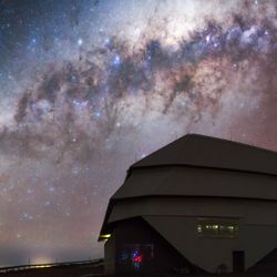 the observatory with behind an incredible night sky with the curve of the Milky way and countless stars