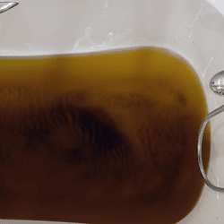 A bath filled with dirty water. 