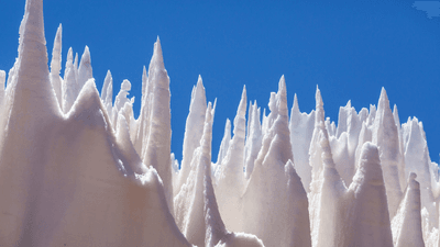 nieves penitentes look like big white icy spikes against the blue sky