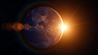 The Earth, with the Sun behind it (artist impression).