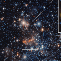 The galaxy is a group of close stars in the middle with many other stars and galaxies ar visible in the background. The inset shows a group of star with a green glow around them, which is the dust.