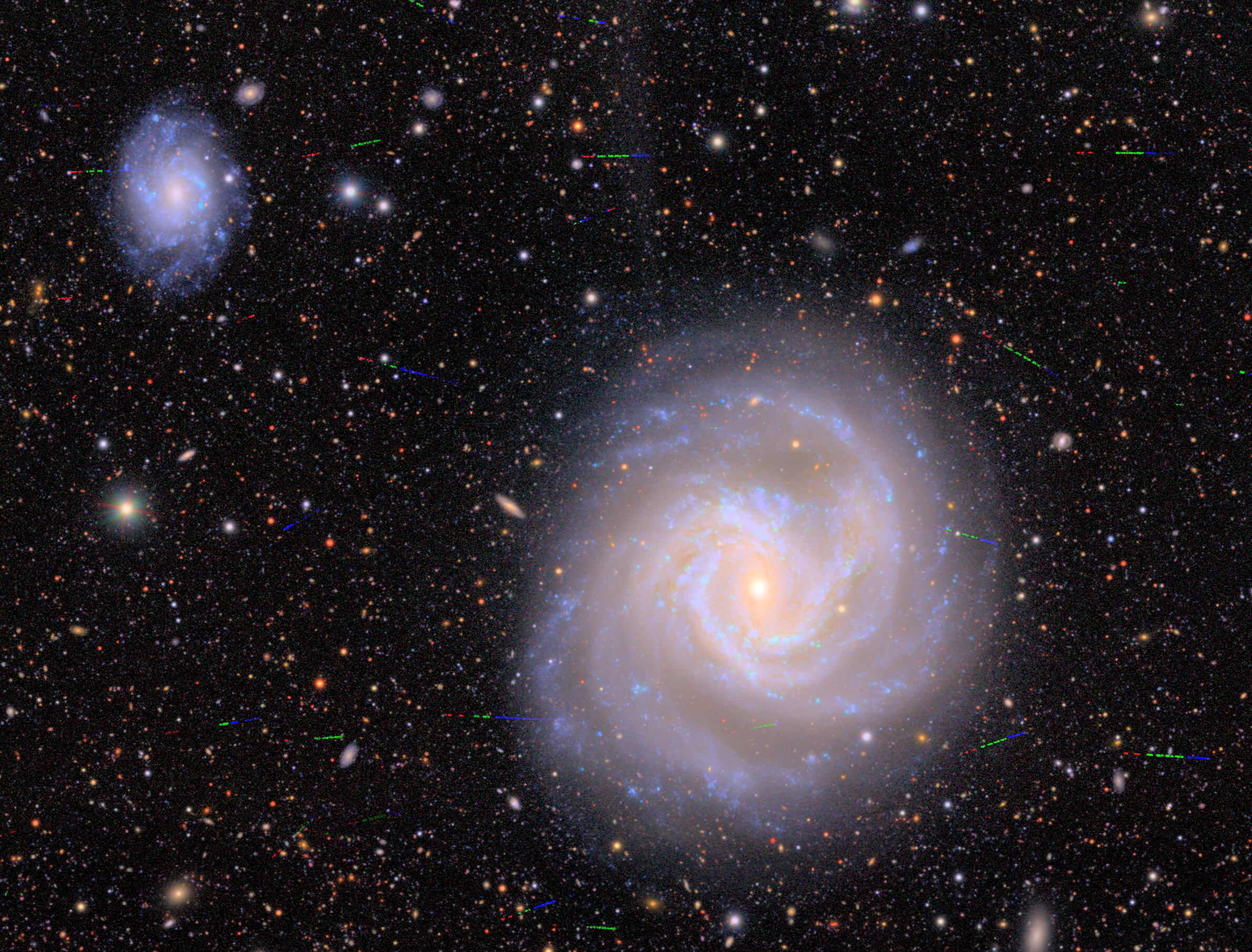If you can tear your eyes away from the spiral galaxy you will see many tiny colored lines, which represent some of the asteroids the Vera Rubin Observatory detected during testing over seven nights in April and May If you can tear your eyes away from the spiral galaxy you will see many tiny colored lines, which represent some of the asteroids the Vera Rubin Observatory detected during testing over seven nights in April and May