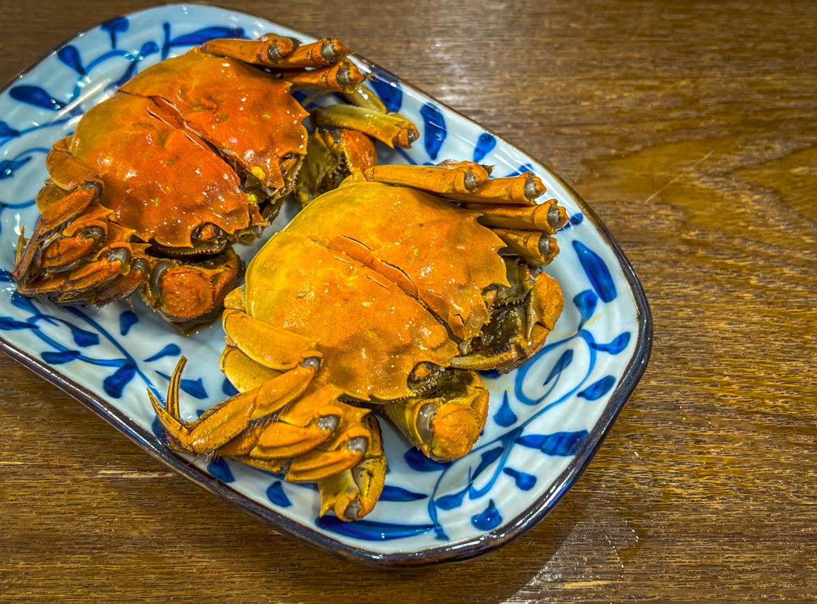 A cooked orange Chinese mitten crab on a plate