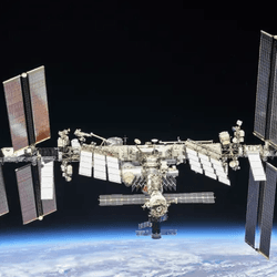 A photo of the international space station floating above the Earth.