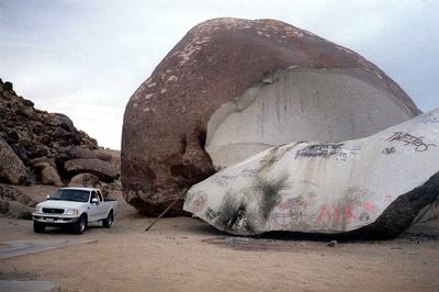 Giant Rock is located in the Mojave Desert near Landers, California (pickup truck for scale).