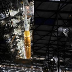 The mobile launcher with NASA’s Artemis II Space Launch System (SLS) rocket and Orion spacecraft secured to it is seen inside the Vehicle Assembly Building following the opening of the doors before rolling out to Launch Pad 39B, Saturday, Jan. 17, 2026, at NASA’s Kennedy Space Center in Florida. NASA’s Artemis II test flight will take Commander Reid Wiseman, Pilot Victor Glover, and Mission Specialist Christina Koch from NASA, and Mission Specialist Jeremy Hansen from the CSA (Canadian Space Agency), around the Moon and back to Earth.