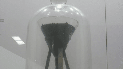 The pitch drop experiment: pitch in a funnel, kept underneath a glass dome.
